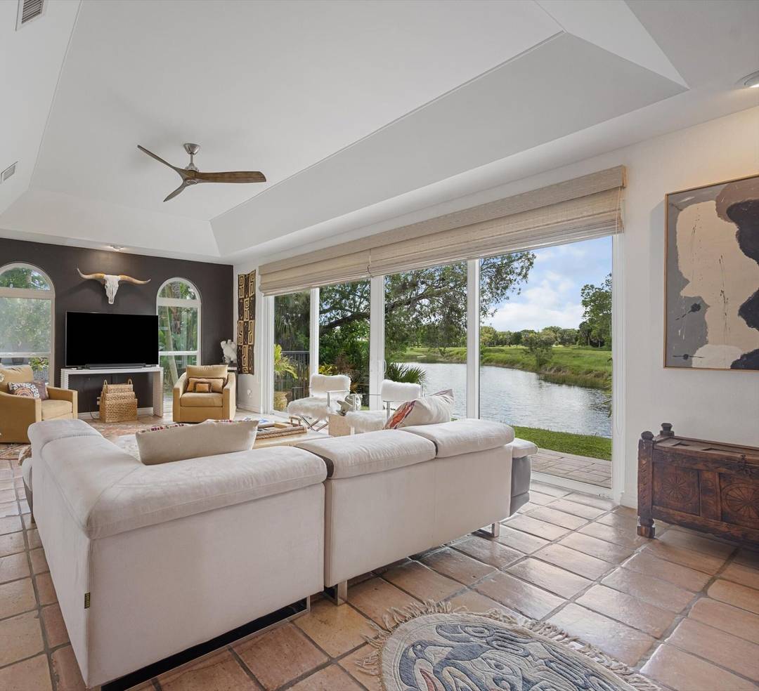 Private beyond compare, this rarely available ground floor, waterfront residence is hidden inside one of Palm Beach Polo's most coveted enclaves.