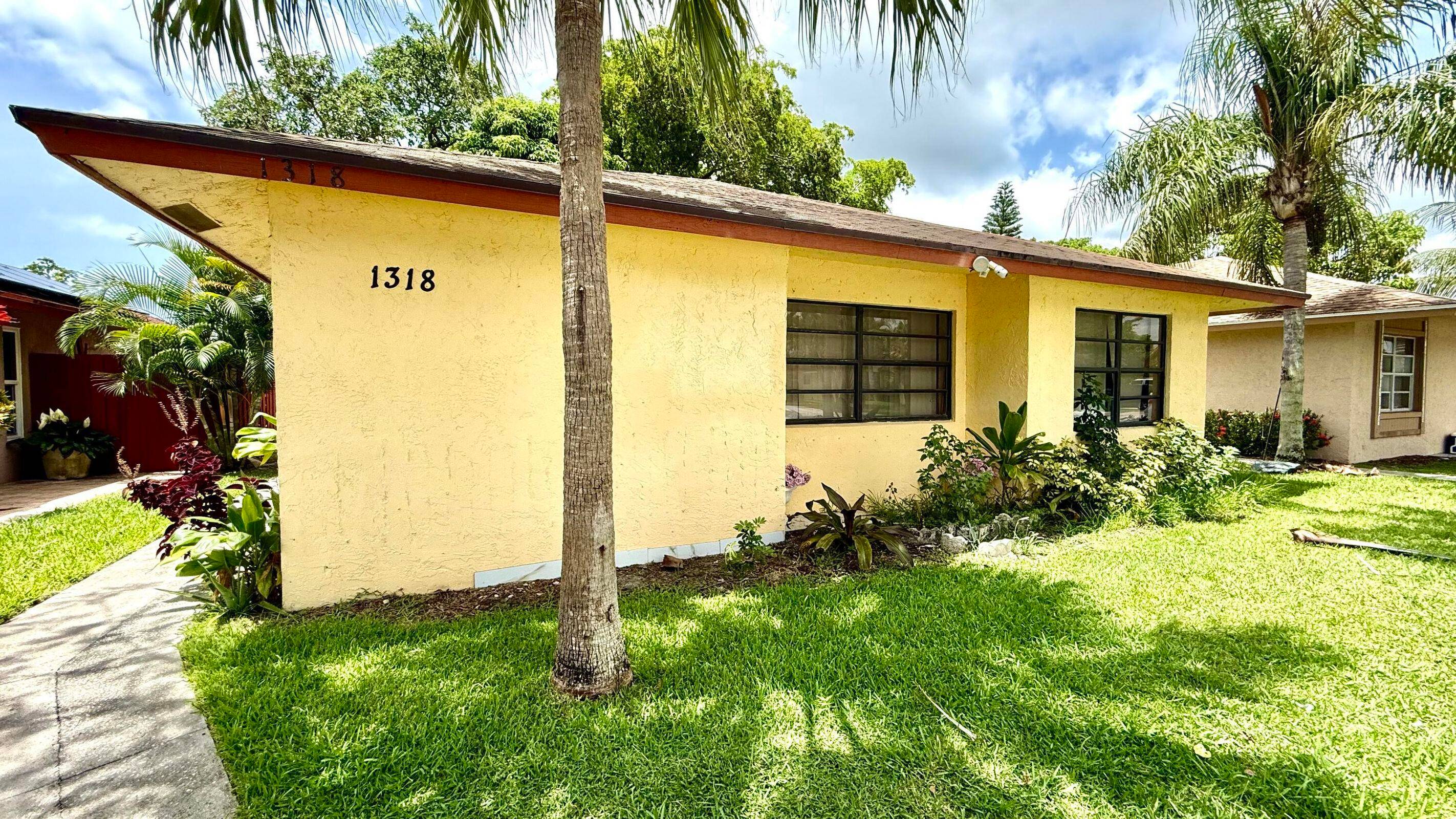 1318 Summit Run Circle is a charming 4 bedroom Den, 2 bath Split floor plan with a shed that will convey nestled in the heart of Greenacres.