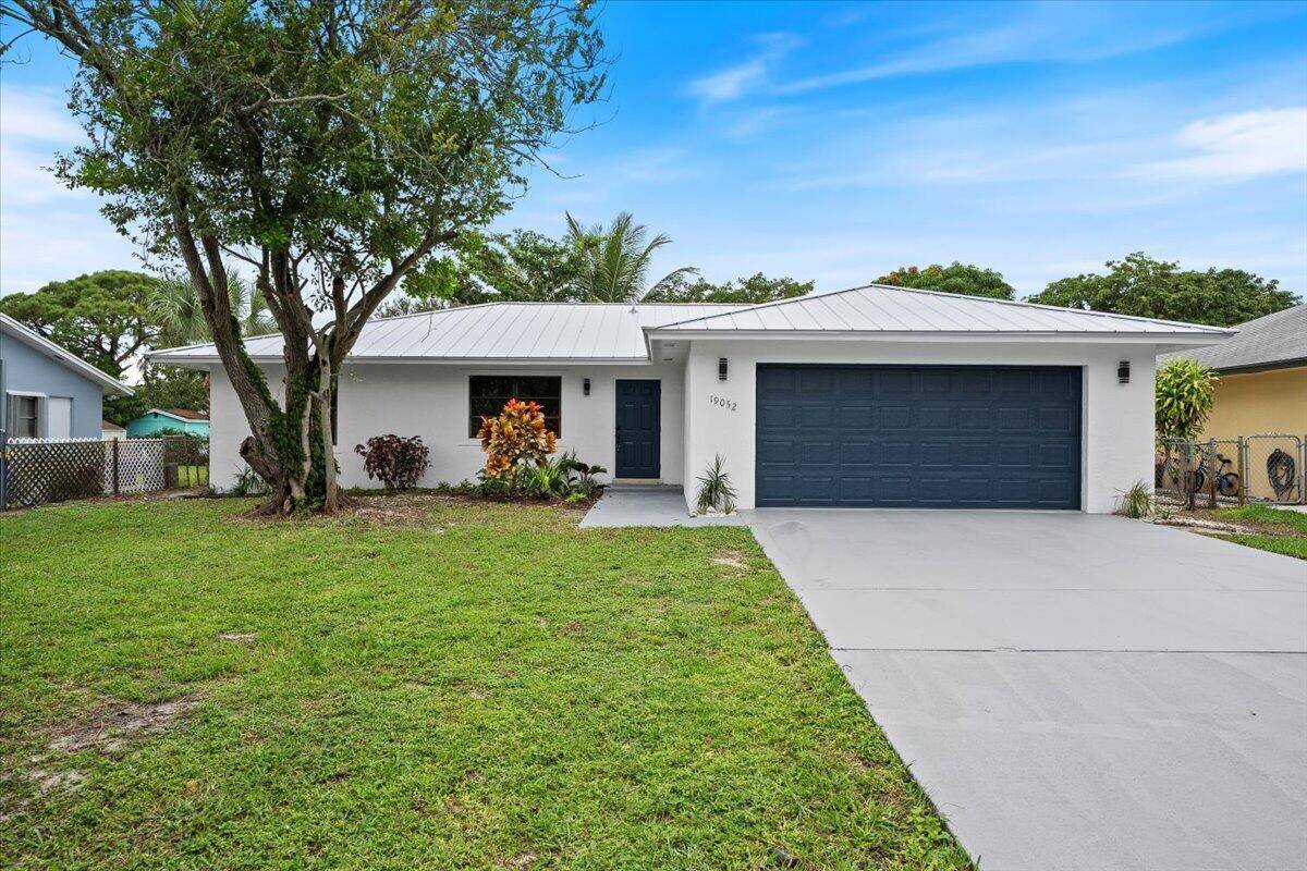 Experience coastal living at its finest with this stunning, fully updated concrete block home just 2.