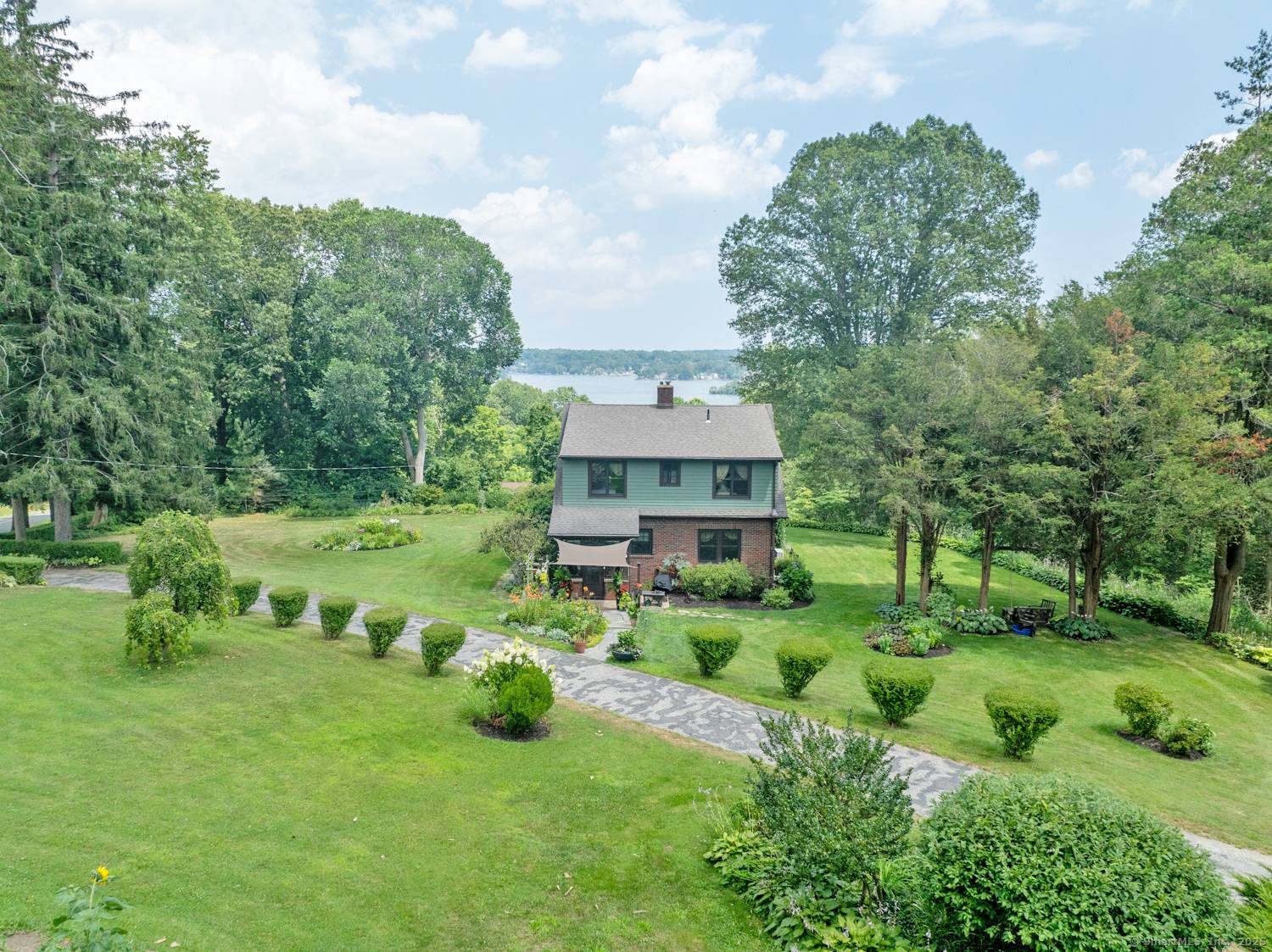 This fully dormered Craftsman style cape overlooking Lake Pocotopaug will captivate you with rich character original period details, a 3 car garage, barn, brook, woods, and enchanting gardens all set ...