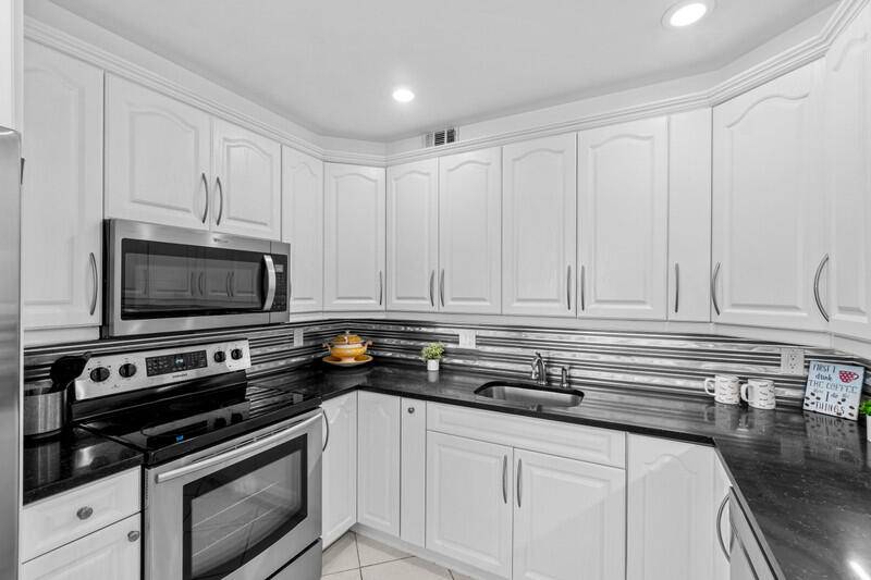 Beautifully renovated 4th floor 2 bedroom, 2 full bath unit in highly desirable Yarmouth in Century Village.