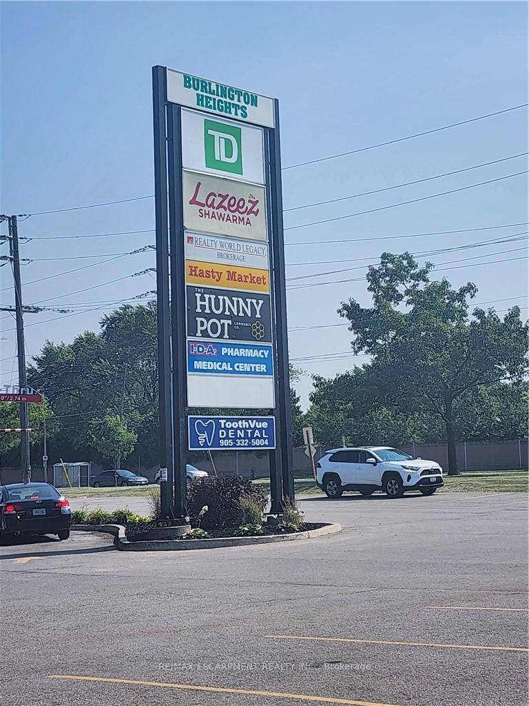 Busy neighborhood shopping centre at signalized intersection of Guelph Line and Upper Middle Road.