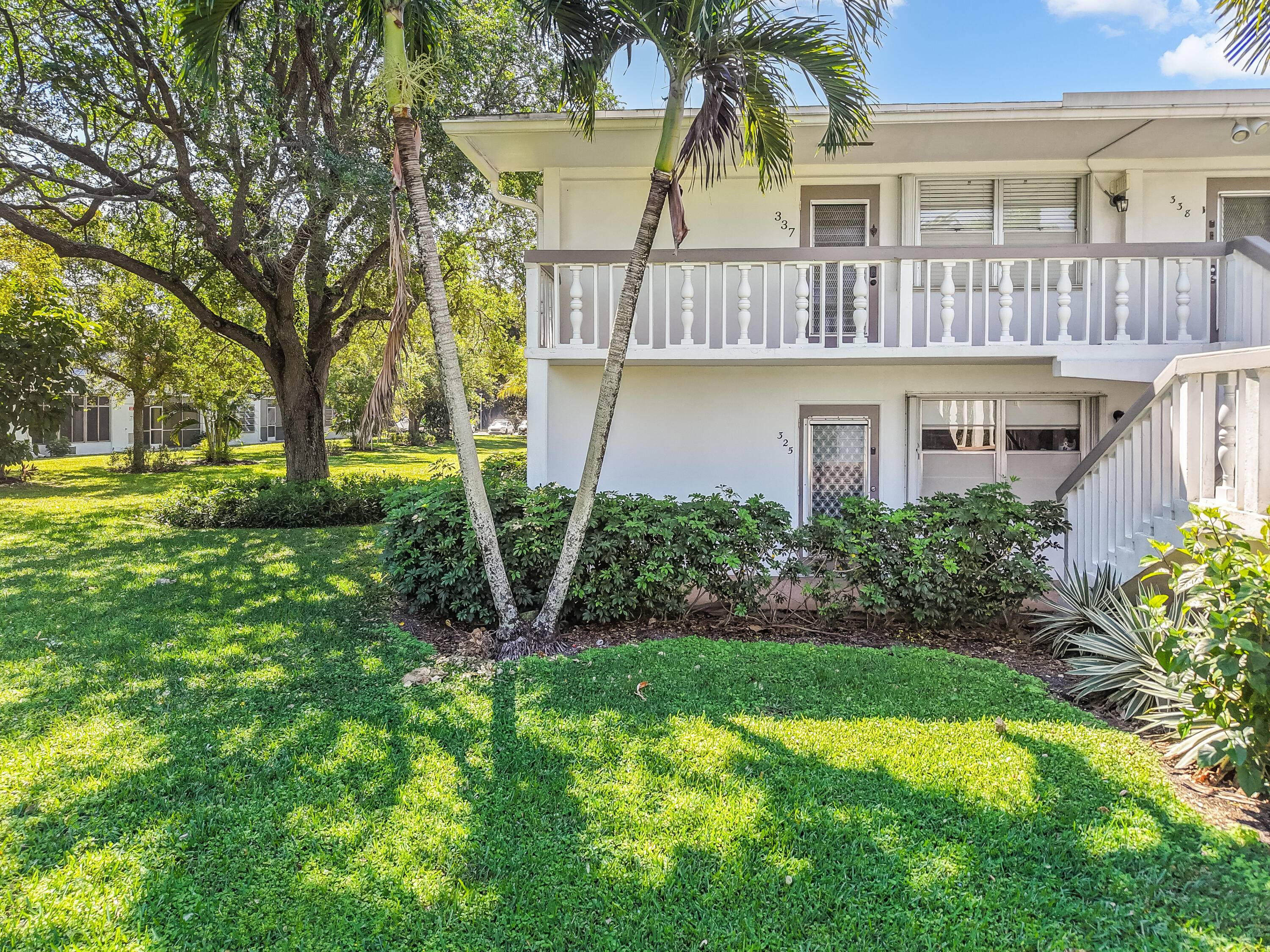 Enjoy the comfort and convenience of this bright, sunlit ground floor corner unit, featuring tile flooring throughout, an updated kitchen, and a cozy patio overlooking a serene garden.
