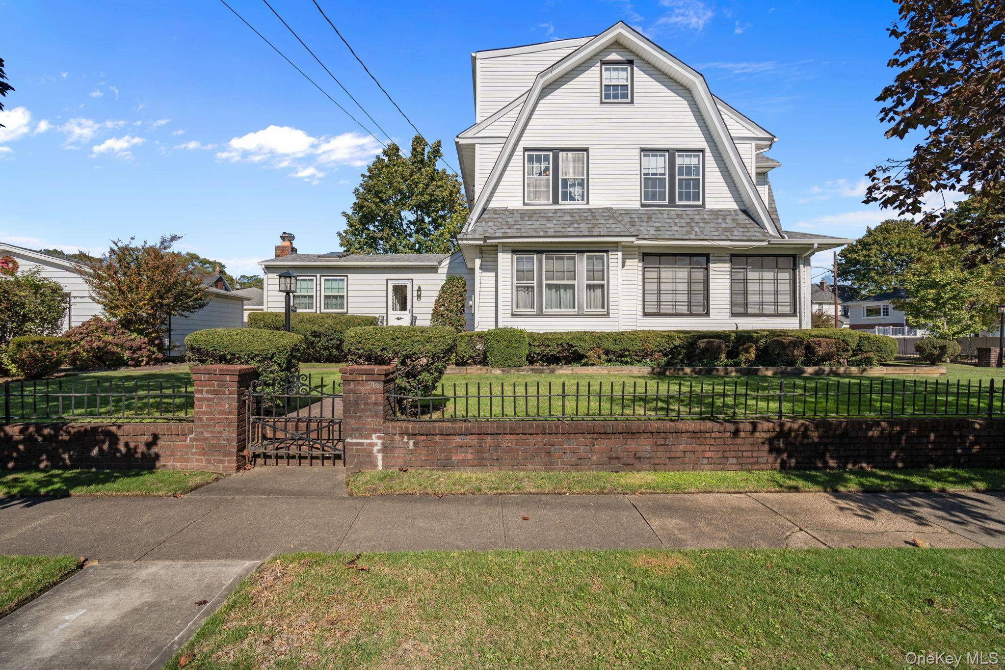Located in the heart of Lynbrook, this Classic Tudor Style home has retained its Beauty and Charm with Rich Chestnut Paneling and Beautiful Trim throughout various parts of the home.