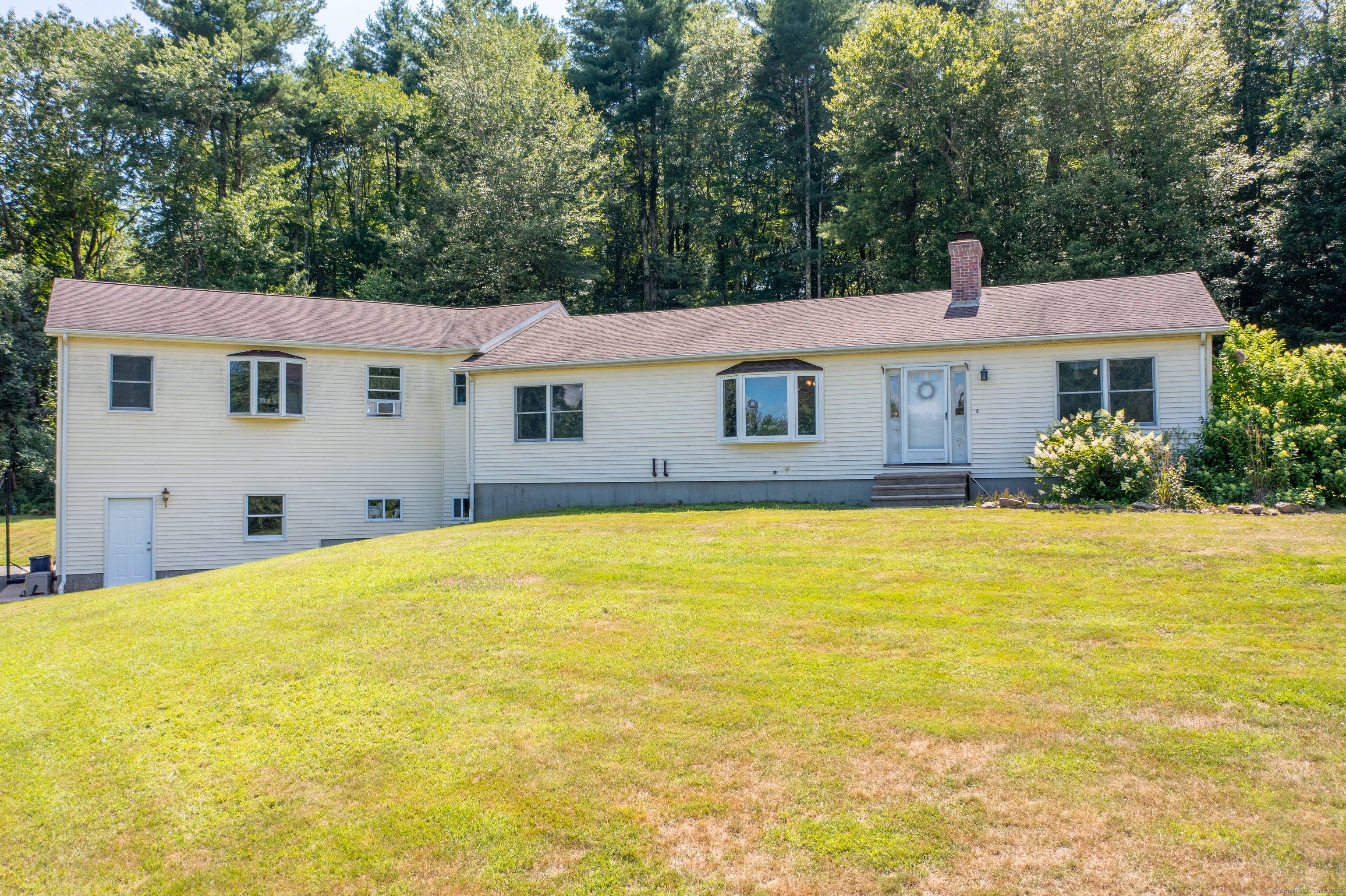 Perched atop a scenic hill, this sprawling ranch offers incredible versatility with a full in law apartment and breathtaking outdoor space.