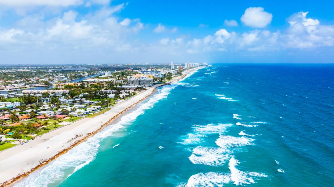 PRIME LOCATION TOWNHOME WITH LOW HOA flanked by the Intracoastal Waterway on one side, and the Atlantic Ocean on the other !