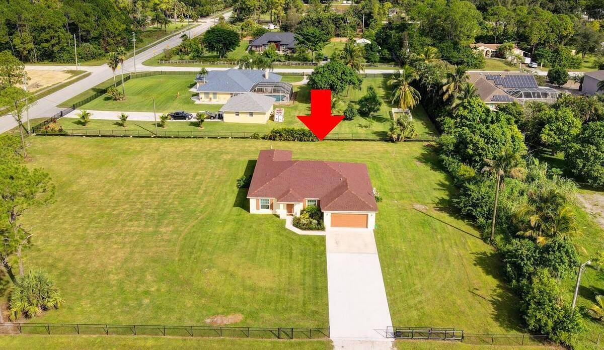 This spacious home with heated pool sits on 1.