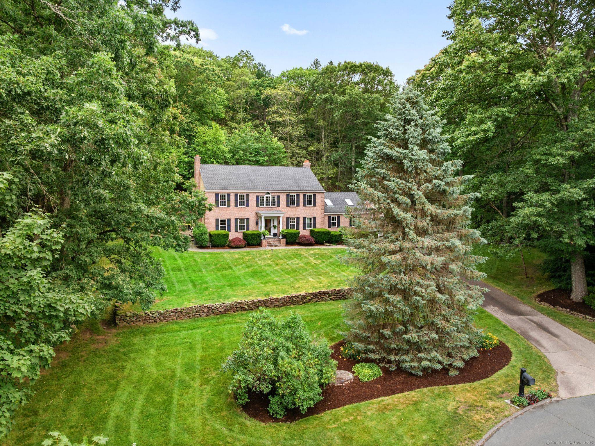 Experience refined New England living in this masterfully crafted colonial, set on 1.