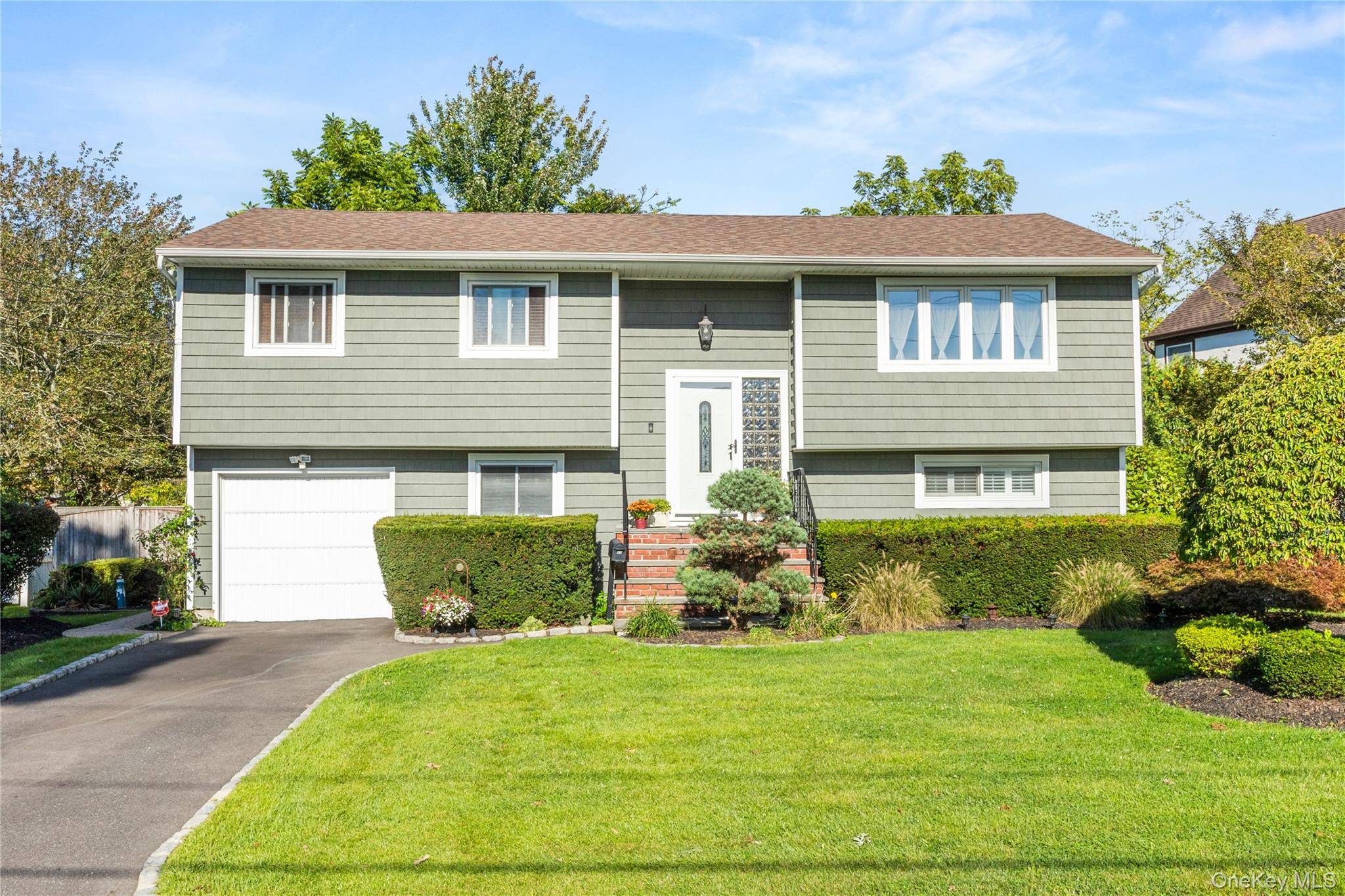 Beautifully maintained 4 bedroom Hi Ranch located in Lawrence Farms features a sunlit classic kitchen with bordeaux marble countertops, a breakfast bar, and sliders leading to an oversized deck, perfect ...