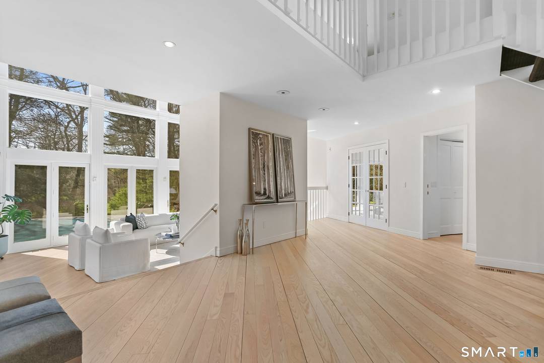 A four season retreat where open lawns, a beautiful pool, and the surrounding landscape create a sense of quiet luxury.