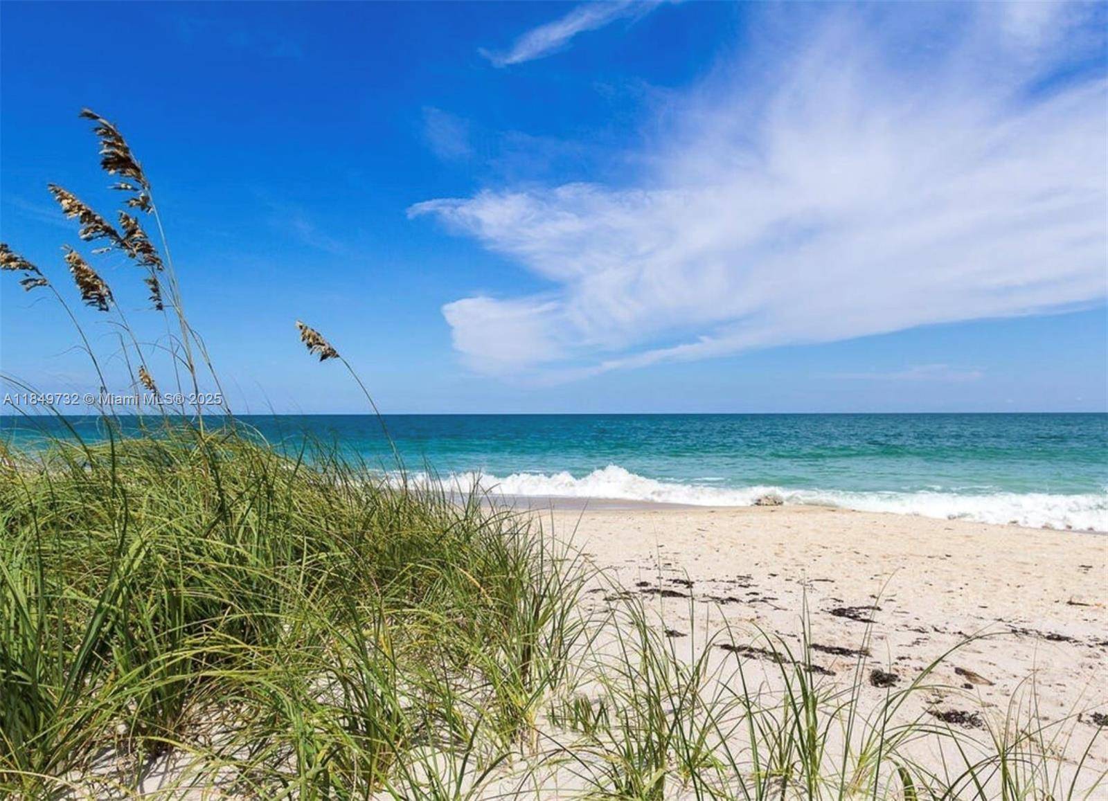 Steps from the Sand Elegant Coastal Living in Winward Indulge in the beachside lifestyle from this refined and spacious first floor residence, ideally located east of A1A in Windward community.