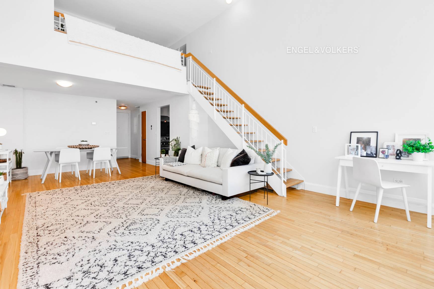 Luxuriously appointed, oversized duplex loft with 16 foot ceilings and a wall of 12 foot tall super quiet industrial tilt and turn windows.