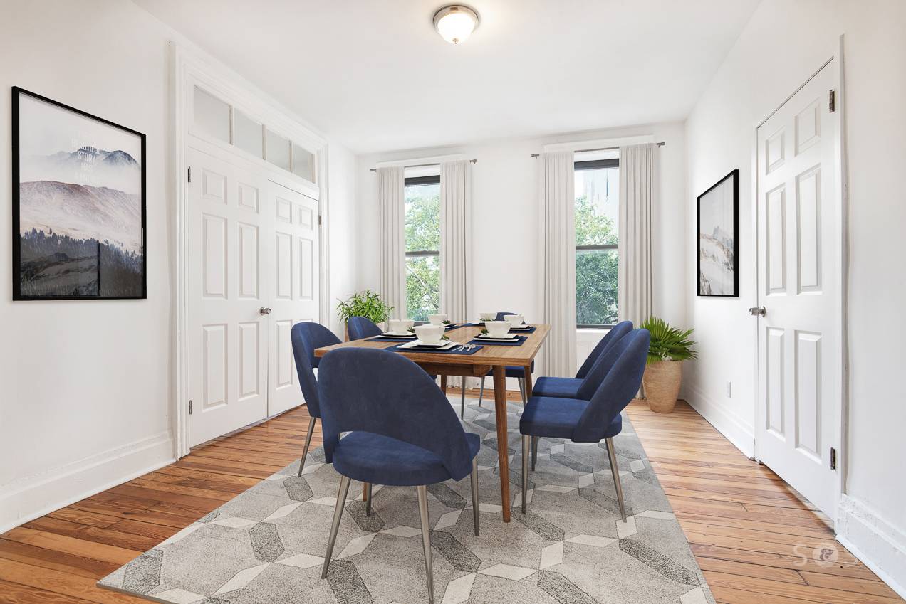 Park facing, two bedroom unit with separate space for living, dining, and two bedrooms on opposite sides of the living room.