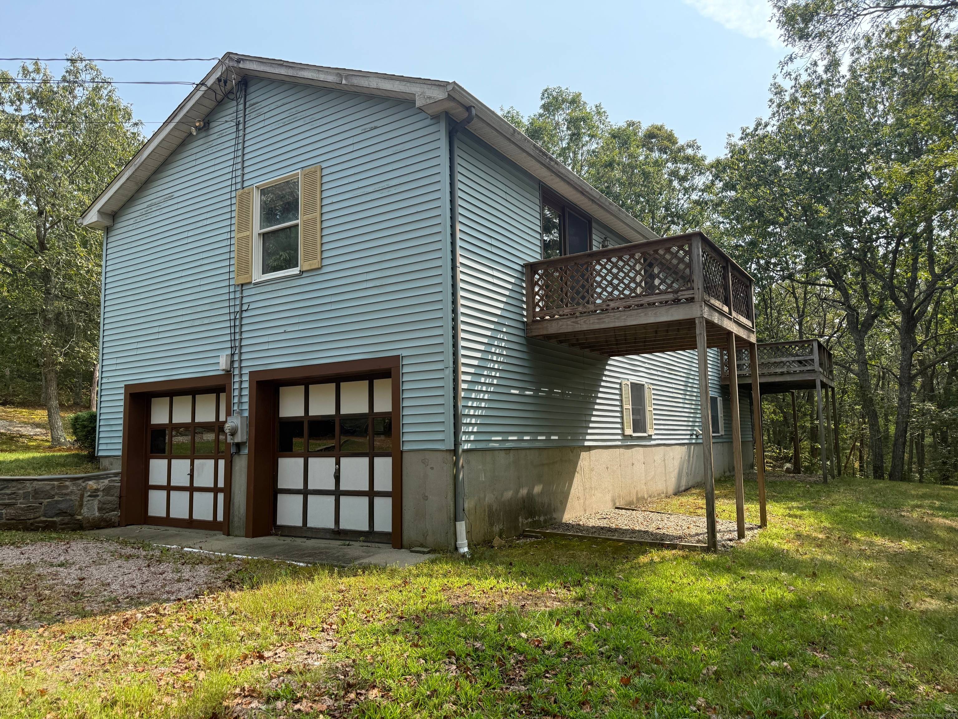 This 1990 raised ranch sits off the road on a shared driveway with 5.