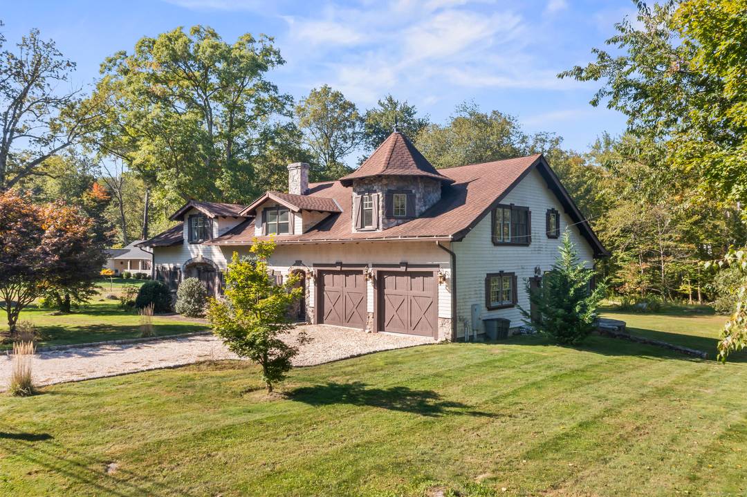 Reminiscent of an European Estate this 4420 square foot home features, four bedrooms, two full bathrooms and two half bathrooms on an open acre of land.