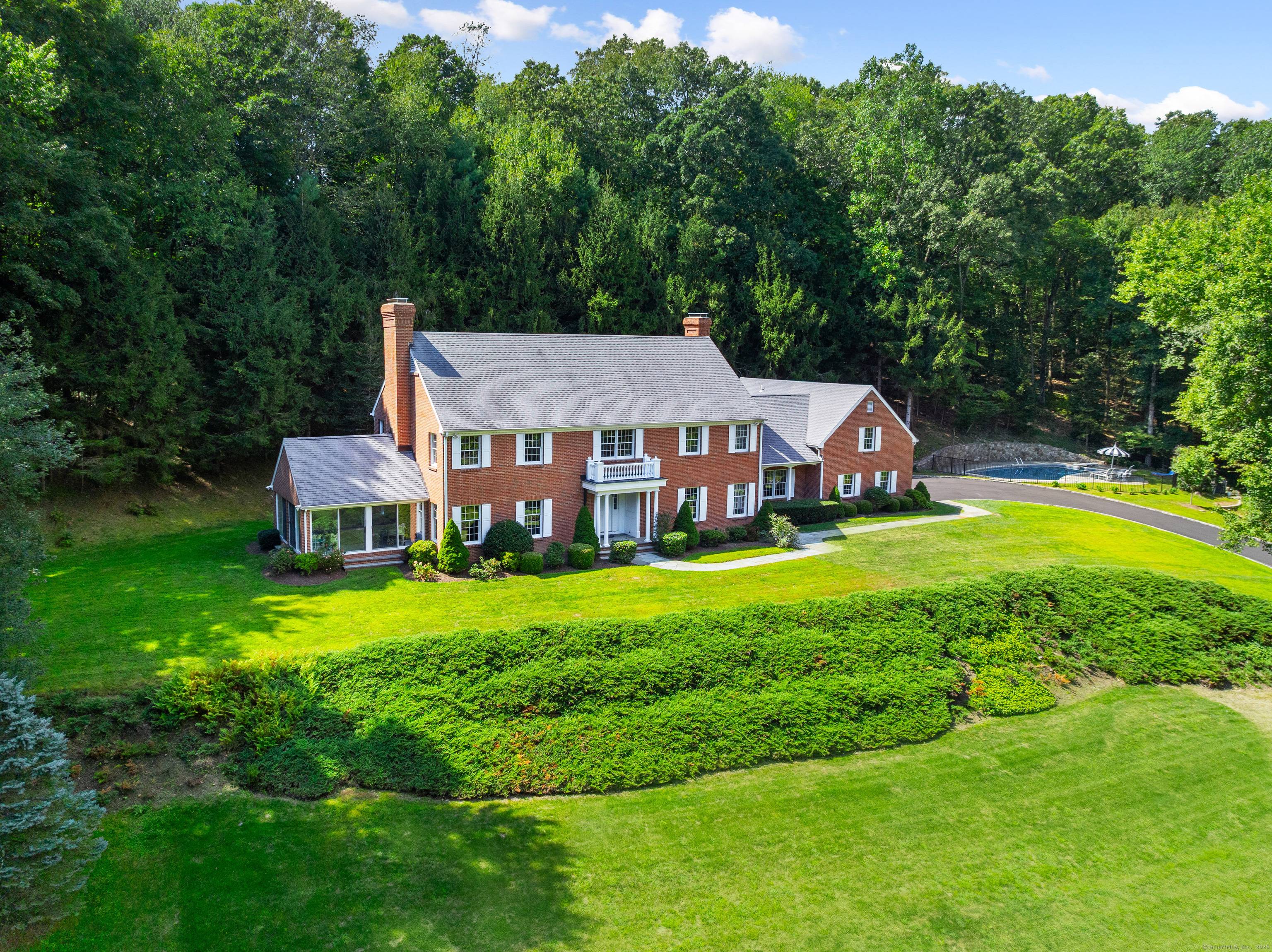 Through stone columns along a scenic approach is this first time on market custom built five bedroom brick house on four private acres.