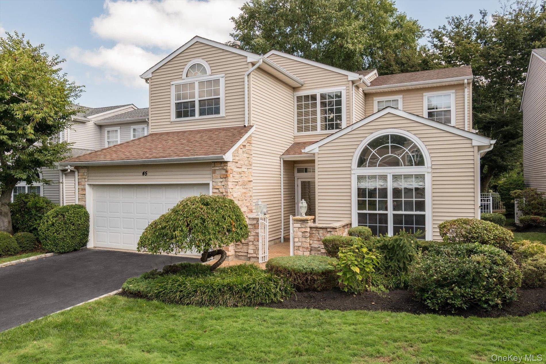 Welcome to 45 Hamlet Drive, nestled within the exclusive 24 hour gated community of The Hamlet at Wind Watch in Hauppauge, NY.