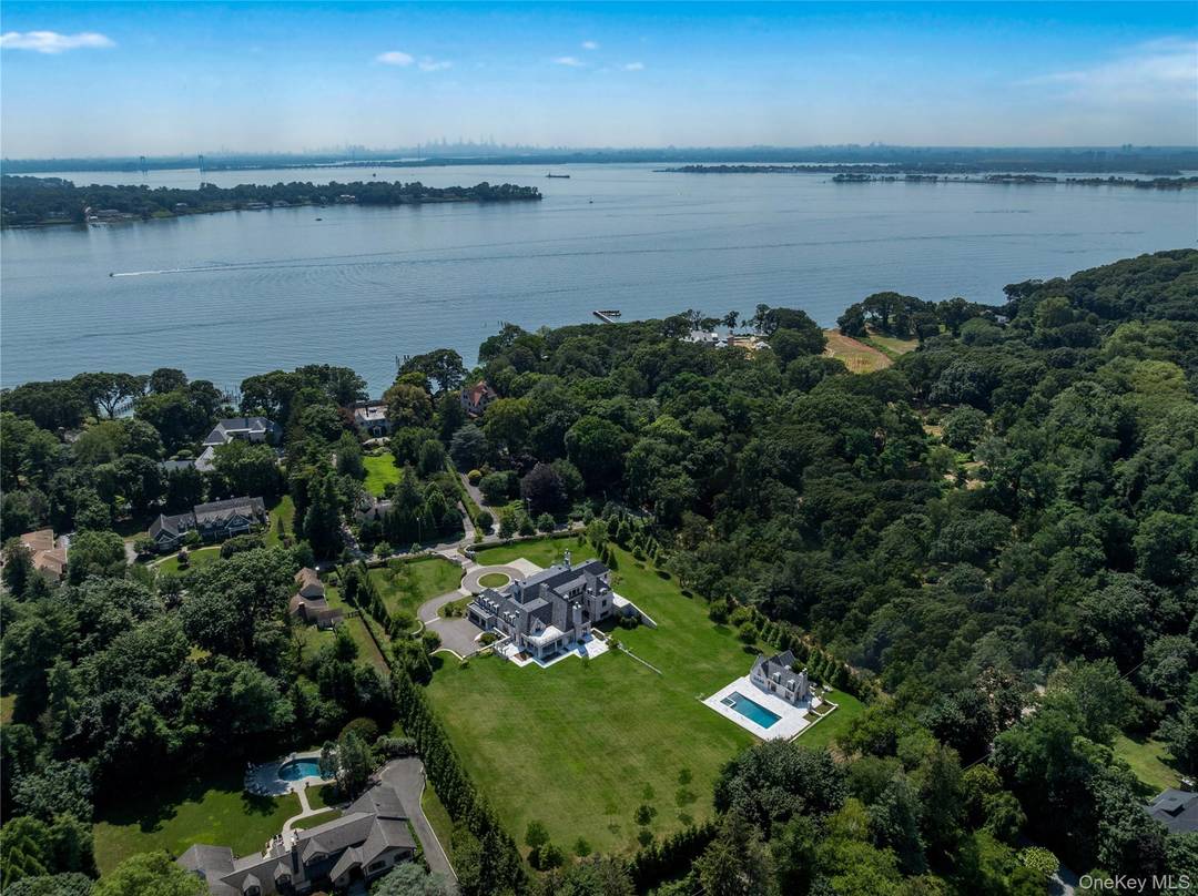 Nestled within the prestigious Village of Sands Point, this stately brick mansion crowned with a handsome slate roof is the epitome of architectural distinction and lasting craftsmanship.