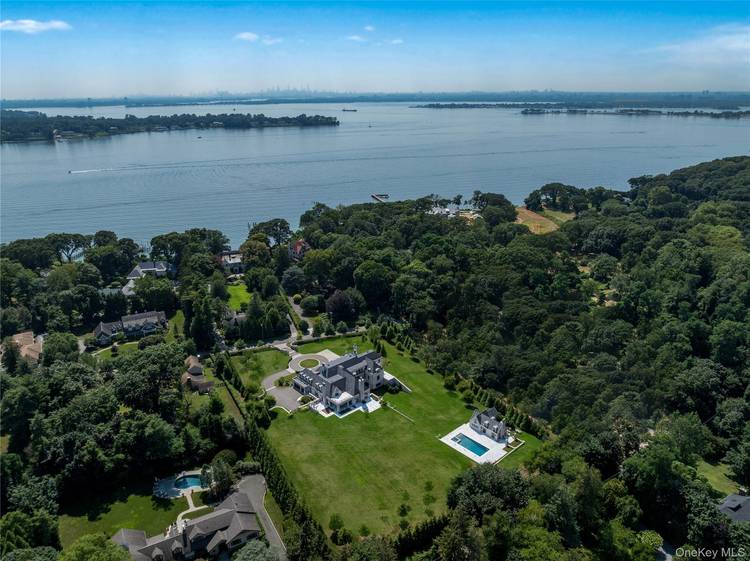 Nestled within the prestigious Village of Sands Point, this stately brick mansion crowned with a handsome slate roof is the epitome of architectural distinction and lasting craftsmanship.