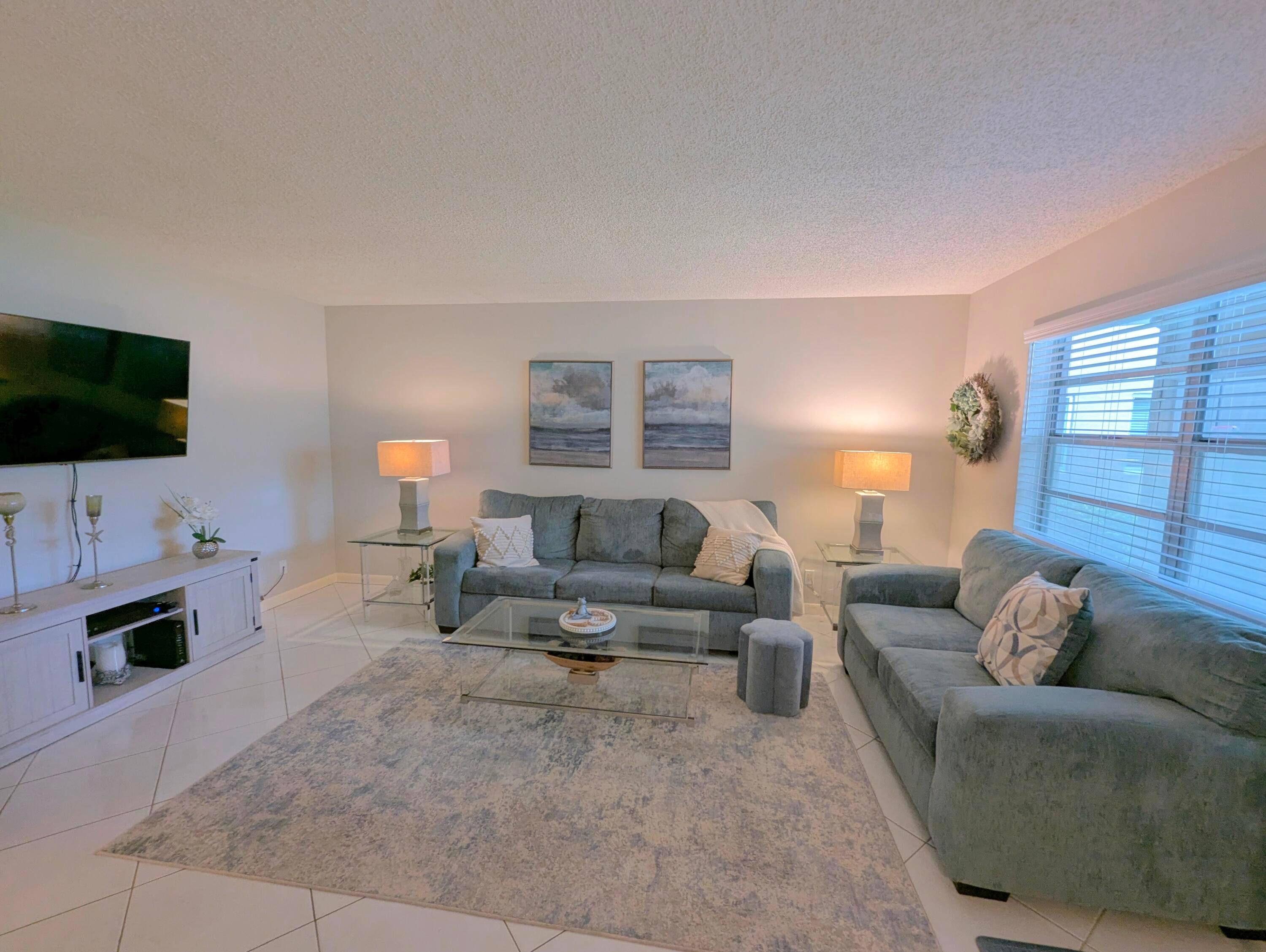 Bright, clean, tastefully updated first floor condo with two bedrooms and two full baths, screened covered patio.