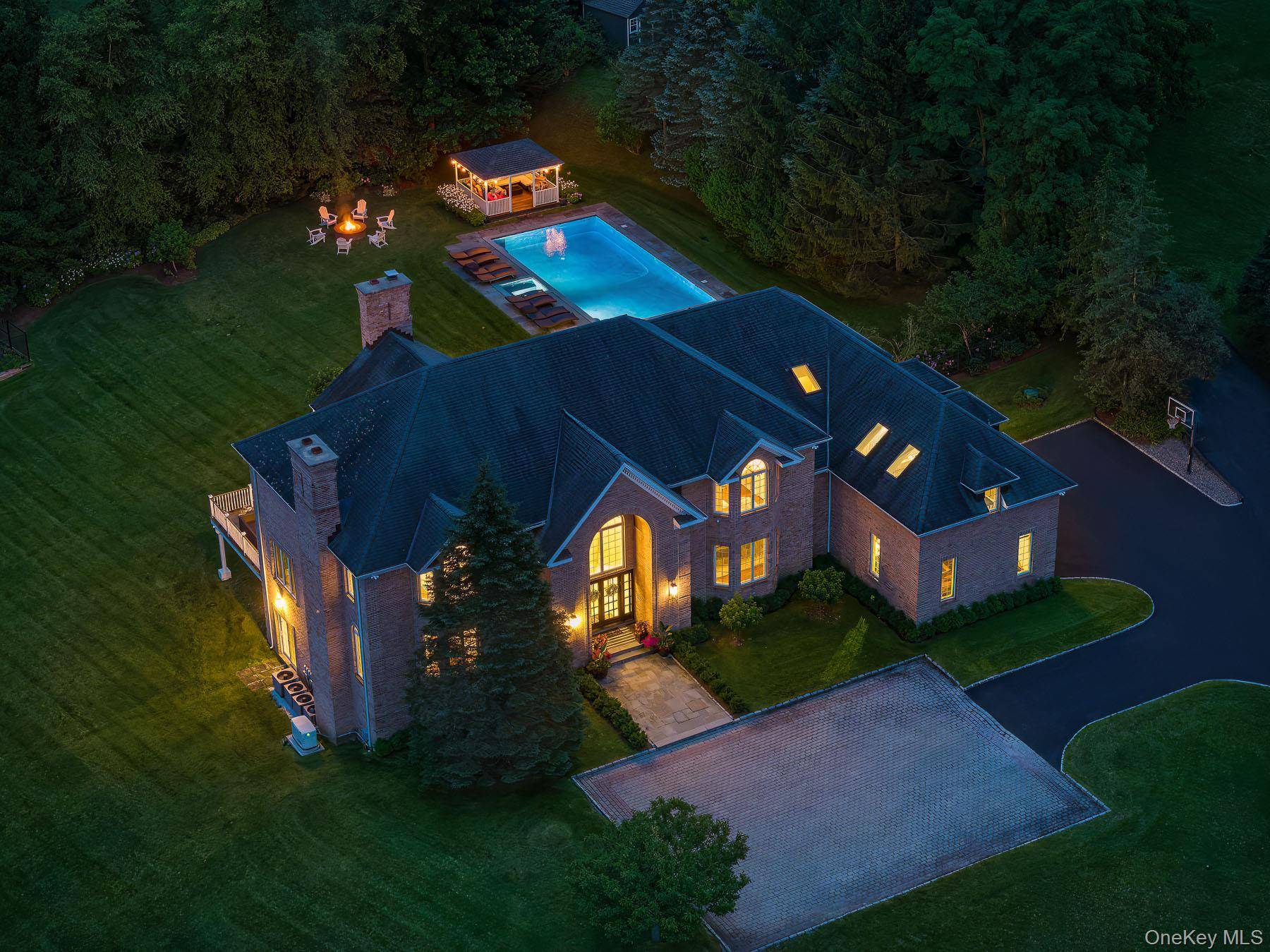 Nestled behind a gated entry on nearly three private acres in Armonk, this stately brick colonial offers a world of refined luxury and total seclusion.