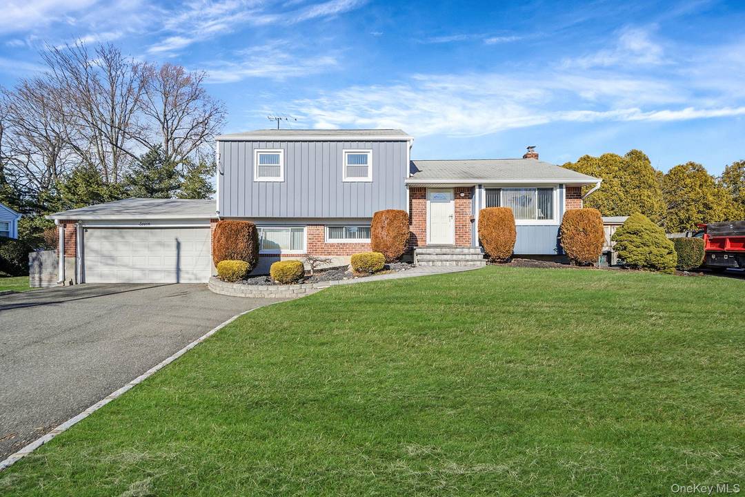Magnificent split level home featuring dual driveways and a two car garage with direct entry into the home.