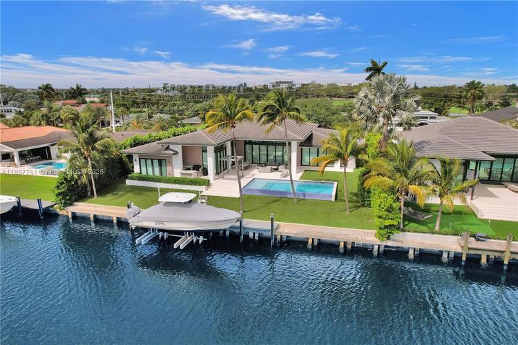 This stunning modern one story residence features floor to ceiling windows with expansive water views from every room.