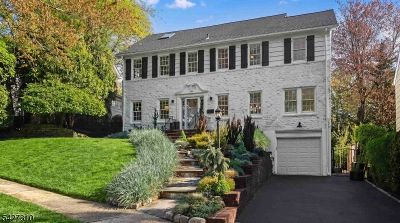 Show stopping curb appeal sets the tone for this stately brick center hall Colonial, where classic architecture meets thoughtful, high end updates.