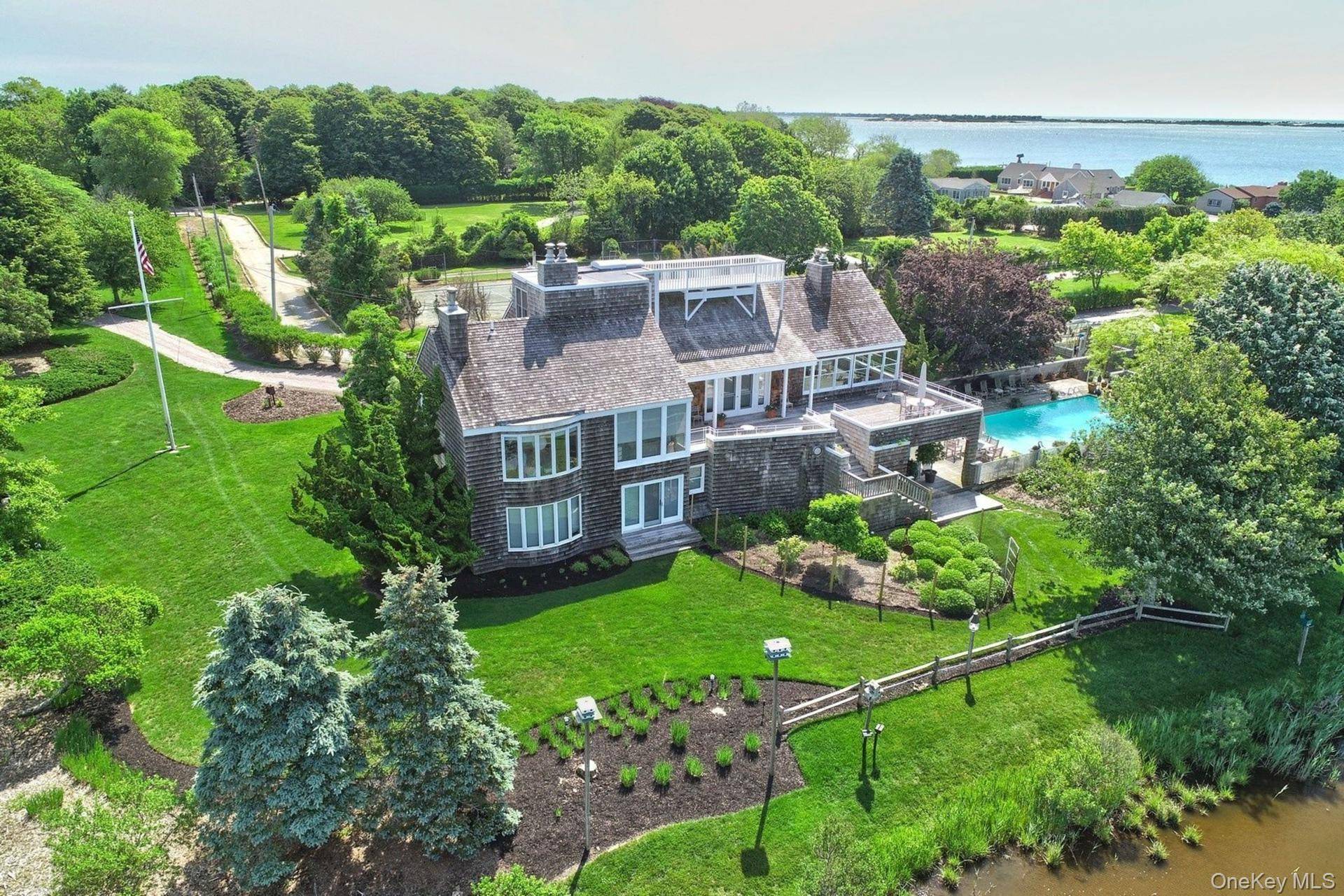 Introducing an extraordinary waterfront estate set on more than six acres along the tranquil shores of Moriches Bay.