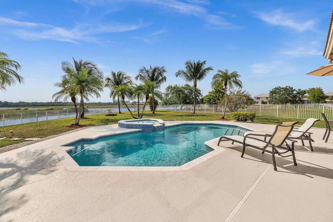 Stunning property with breathtaking views of both the pool and the lake, providing amazing sunsets right from your backyard.