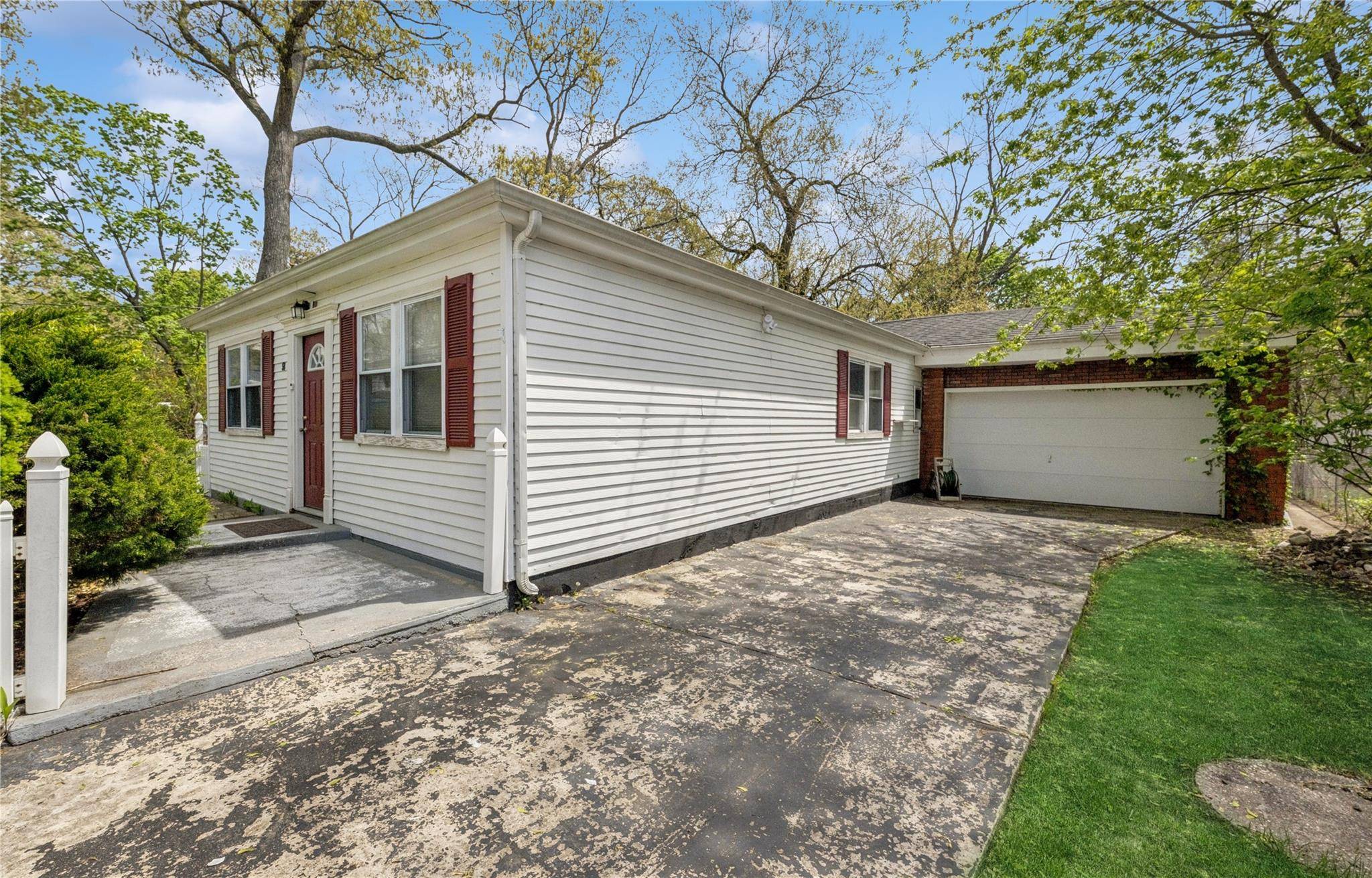 This spacious 4 bedroom, 2 bath ranch offers rare privacy with a deep setback, oversized front yard, and long driveway.