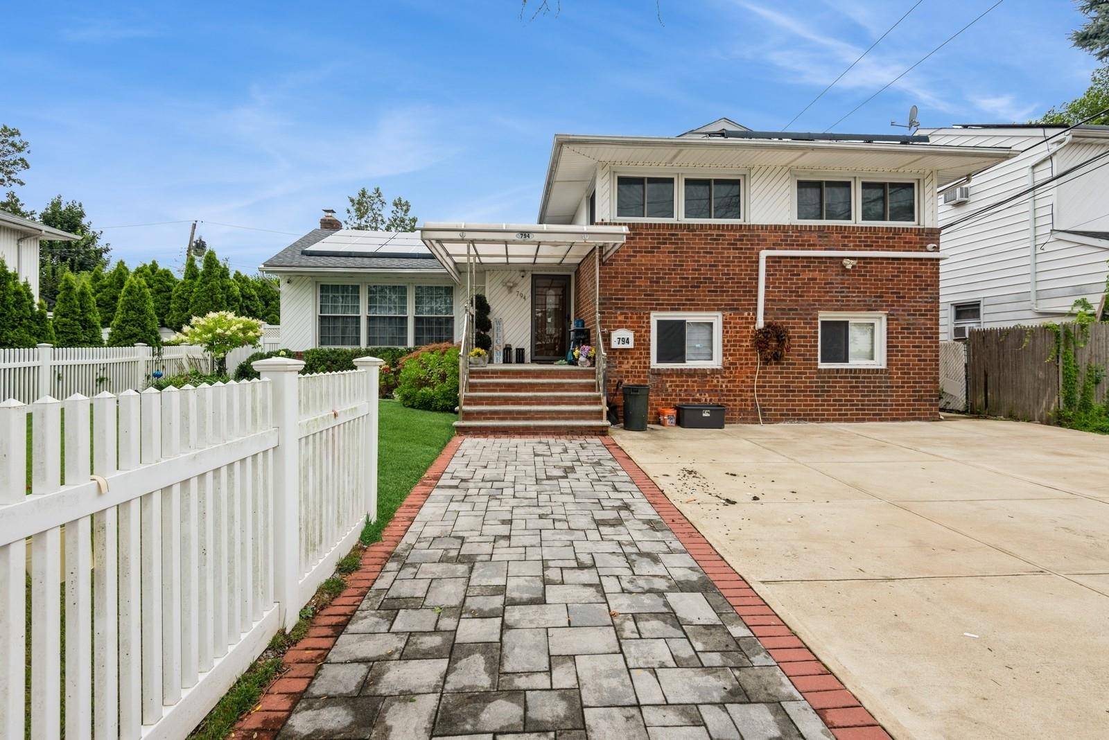 This Cozy East Meadow Split Level C Home Located On An Oversized Lot Offers Privacy And Comfortability All In One !