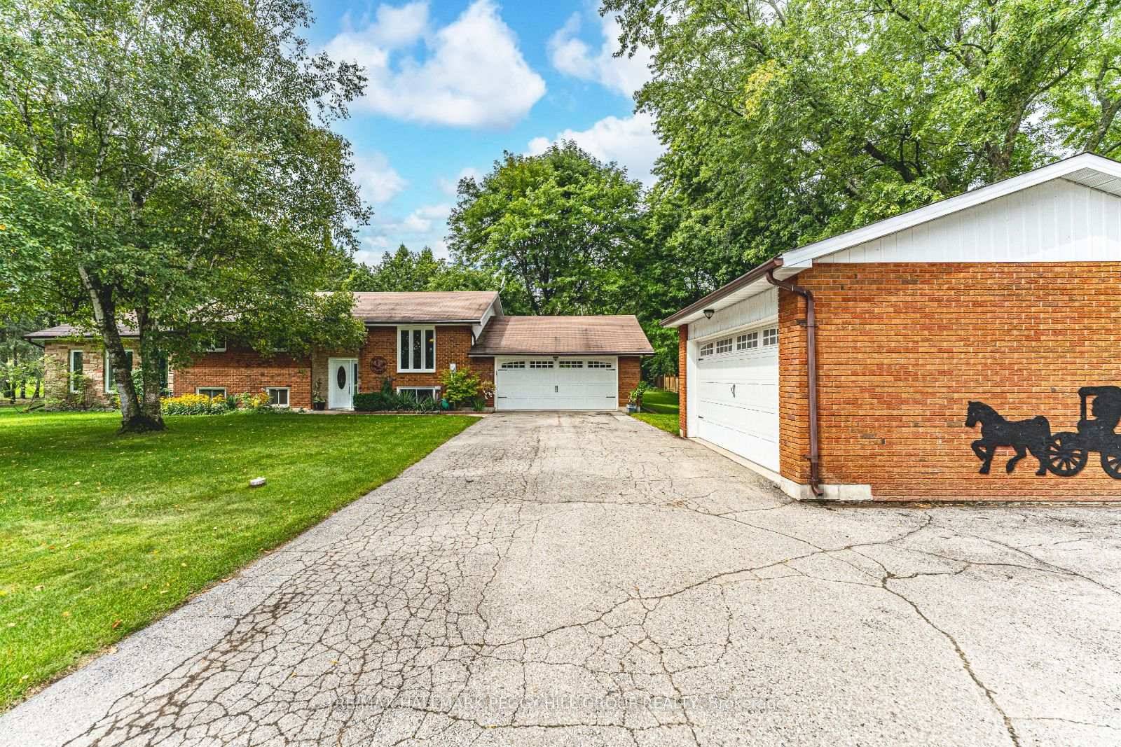 RAISED BUNGALOW ON 1. 2 ACRES WITH A BONUS DETACHED SHOP, SPACIOUS TWO CAR GARAGE, LIGHT FILLED SUNROOM amp ; PEACEFUL BACKYARD RETREAT !