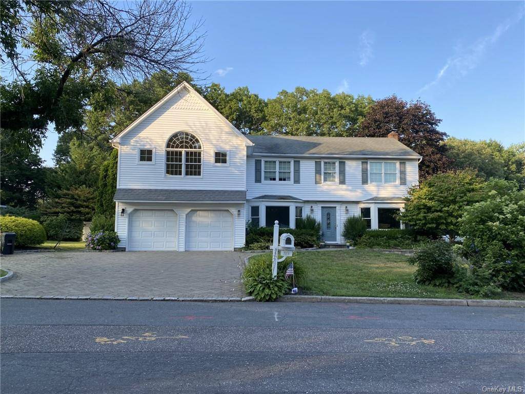 Updated and well appointed home situated on a manicured shy half acre on a tree lined street in Dix Hills.