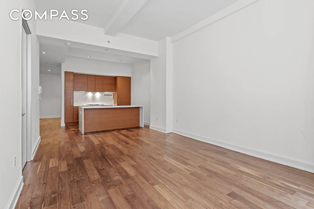 Turnkey loft style residence with oversized windows overlooking West 22nd Street, dramatic 11 foot beamed ceilings, and Italian wide plank oak flooring throughout.