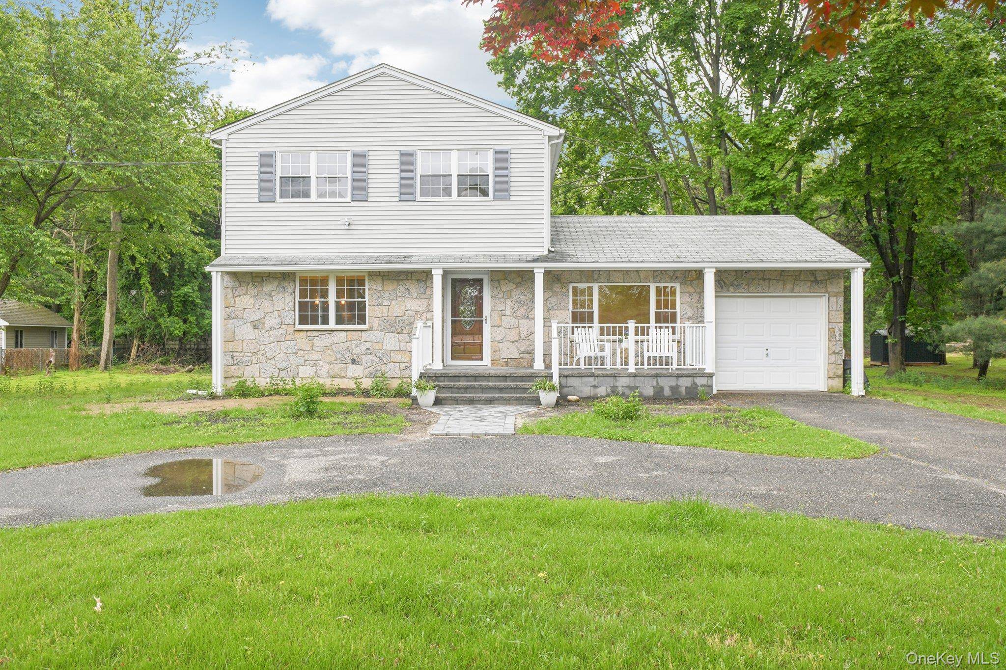Discover this beautifully updated Center Hall Colonial, located in the sought after Swezeytown area of Middle Island.