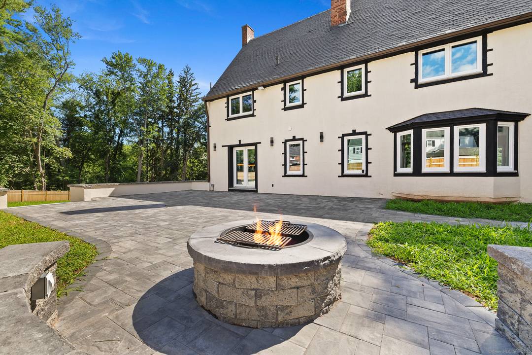 Welcome to this extraordinary European inspired brick and stucco Tudor estate, situated on a beautifully landscaped, level.