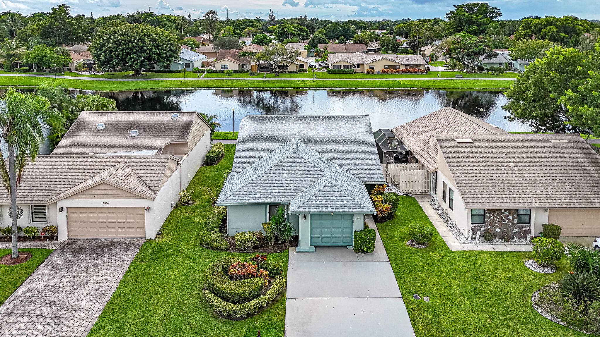 WATERFRONT RETREAT ! New Roof 2024 Gorgeous Lake Views Extended Florida Room with Full Wall Of Sliders Spacious Floor Plan Vaulted Ceilings LED High Hats Living and Dining Areas with ...