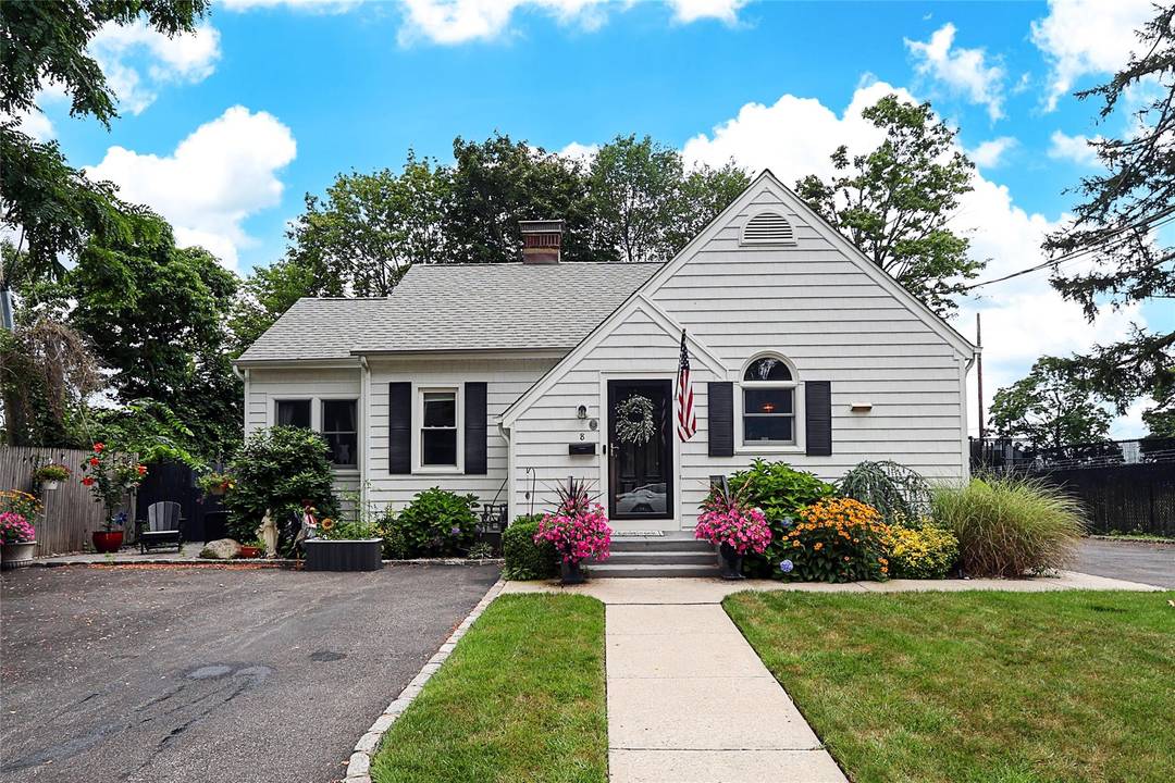 This charming home features two cozy bedrooms and a sunlit sunroom.