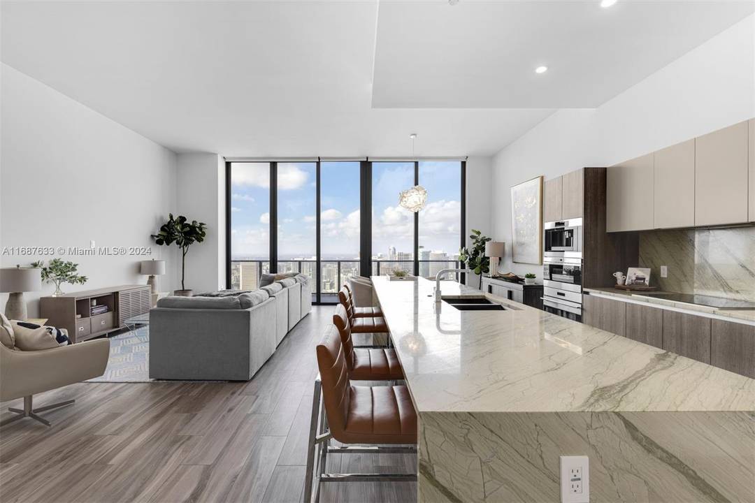 Experience luxury penthouse living in this exquisite 3 bedroom plus den, 4 bath residence with 12' ceilings, offering panoramic skyline and bay views.