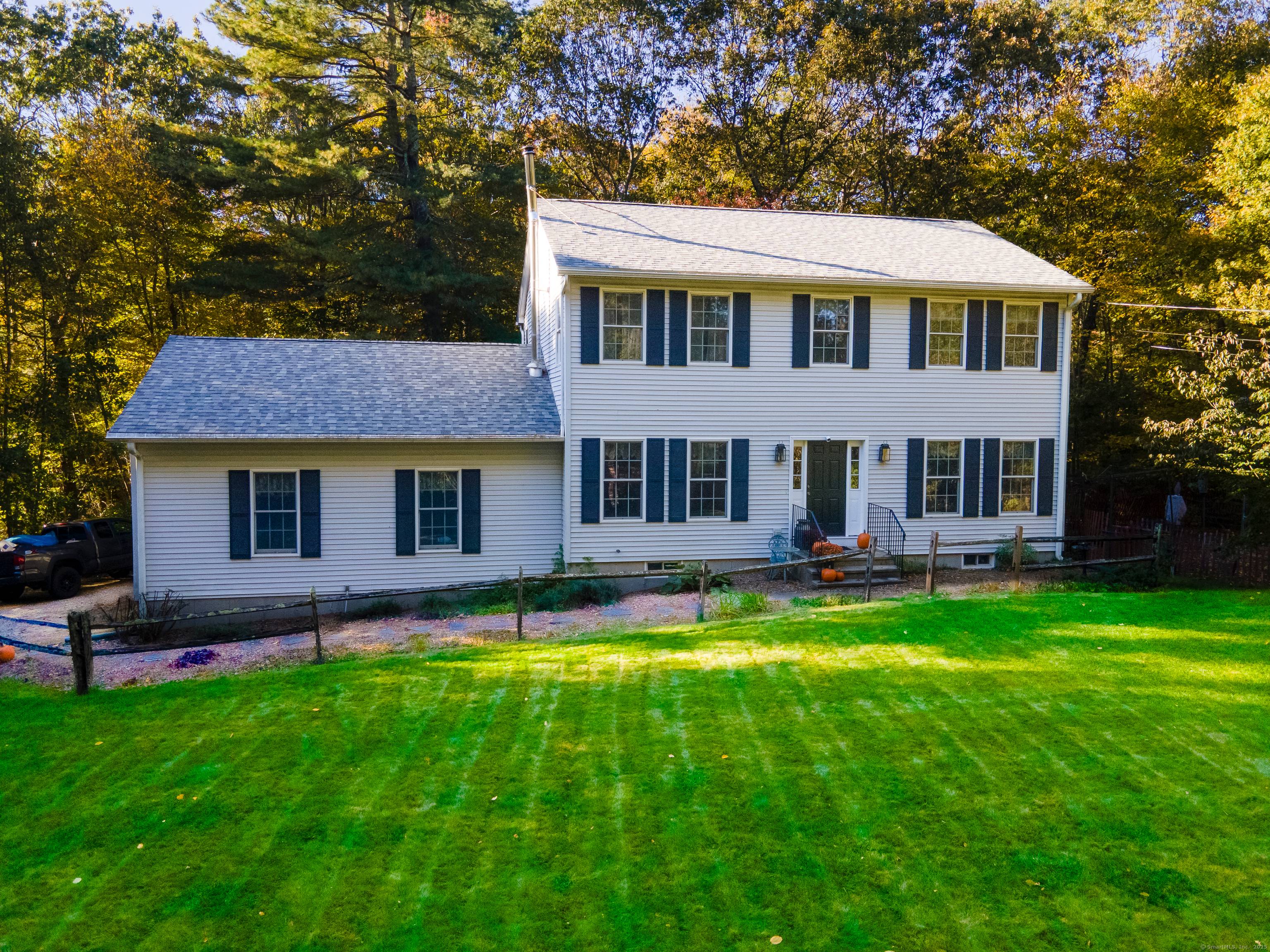 Welcome home to this classic Colonial nestled on a 2 acre country lot in desirable Woodstock !