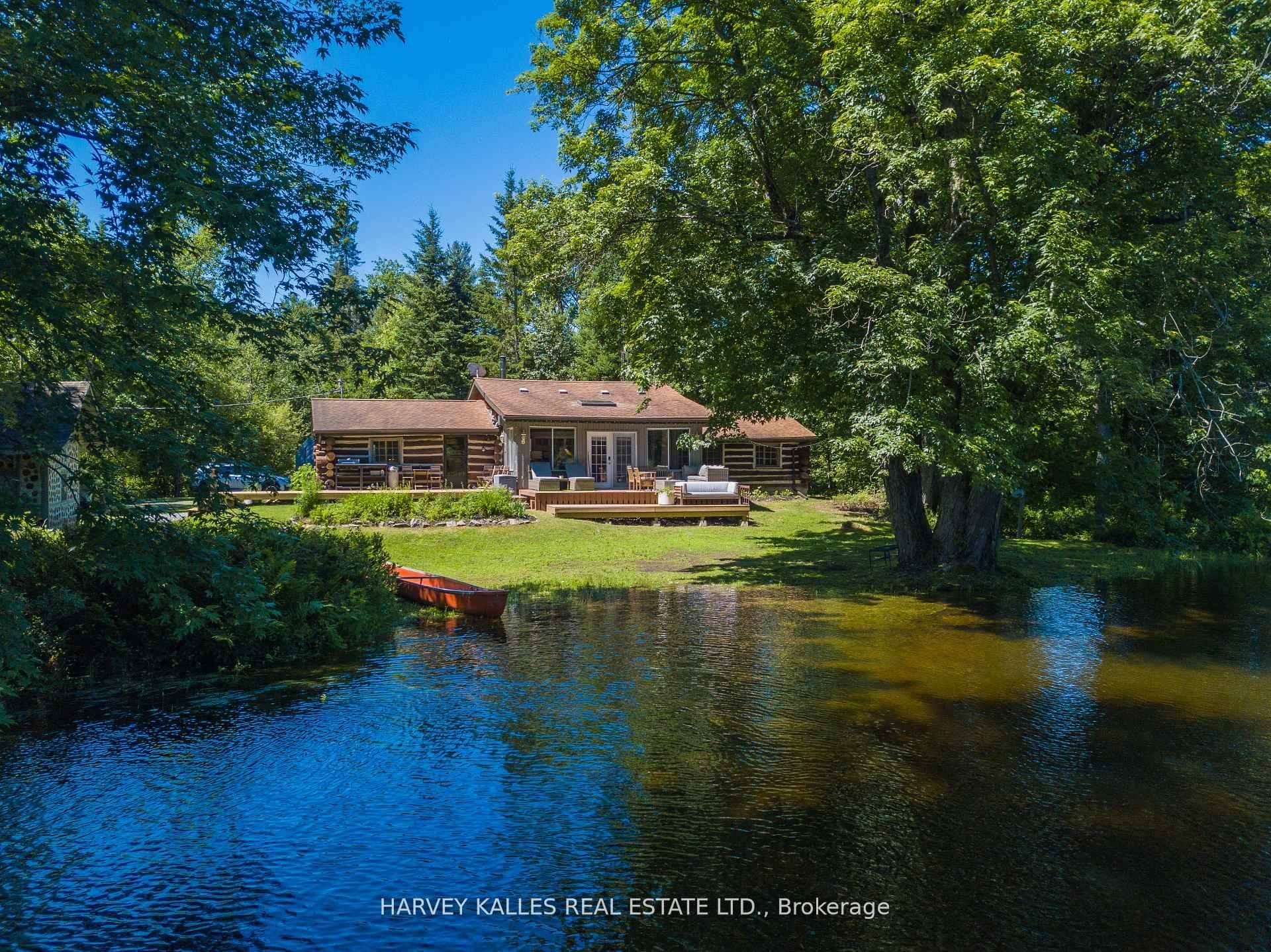 Charming and fully updated 4 season round log cottage on the Muskoka River, set on a rare double lot with 3.