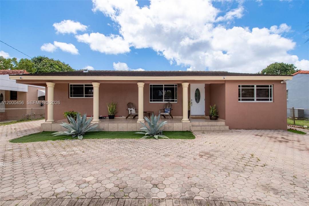 Beautiful gated property featuring a swimming pool and a spacious lot, perfect for entertaining and enjoying the South Florida lifestyle.