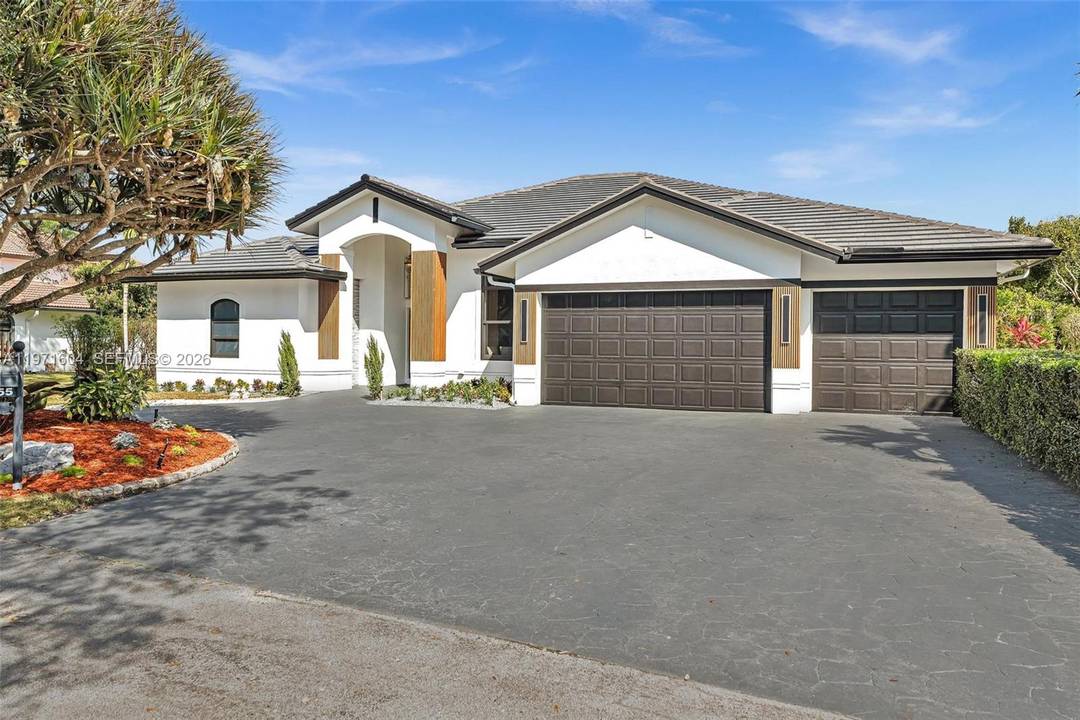 Welcome to this exceptional estate in the prestigious Kapok Village Estates in Davie.