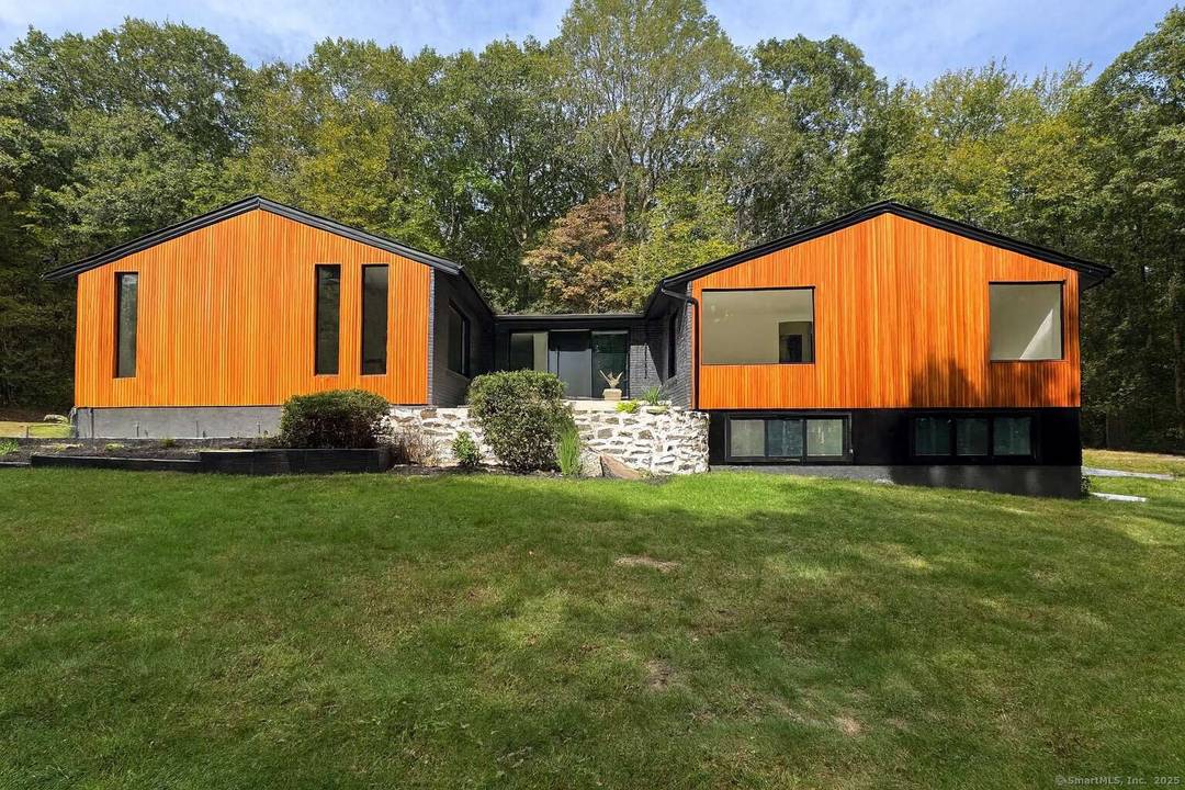 Set against the scenic Woodbridge Land Trust, this spacious 5 bedroom, 3.