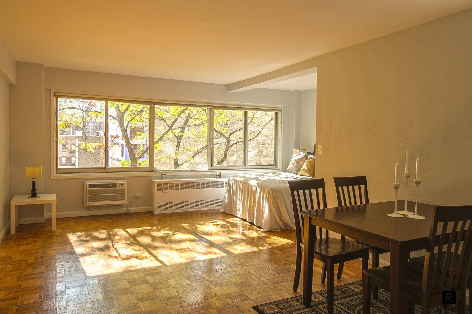 18 feet of windows facing south to quiet courtyard gardens !