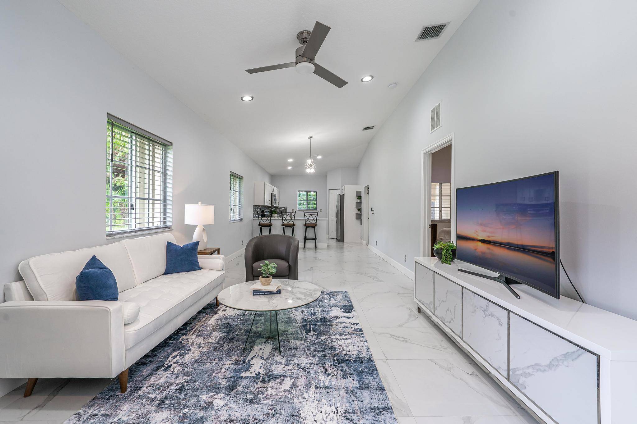 Rarely available, absolutely stunning corner unit in the pristine and luxurious 55 community of Baywinds !