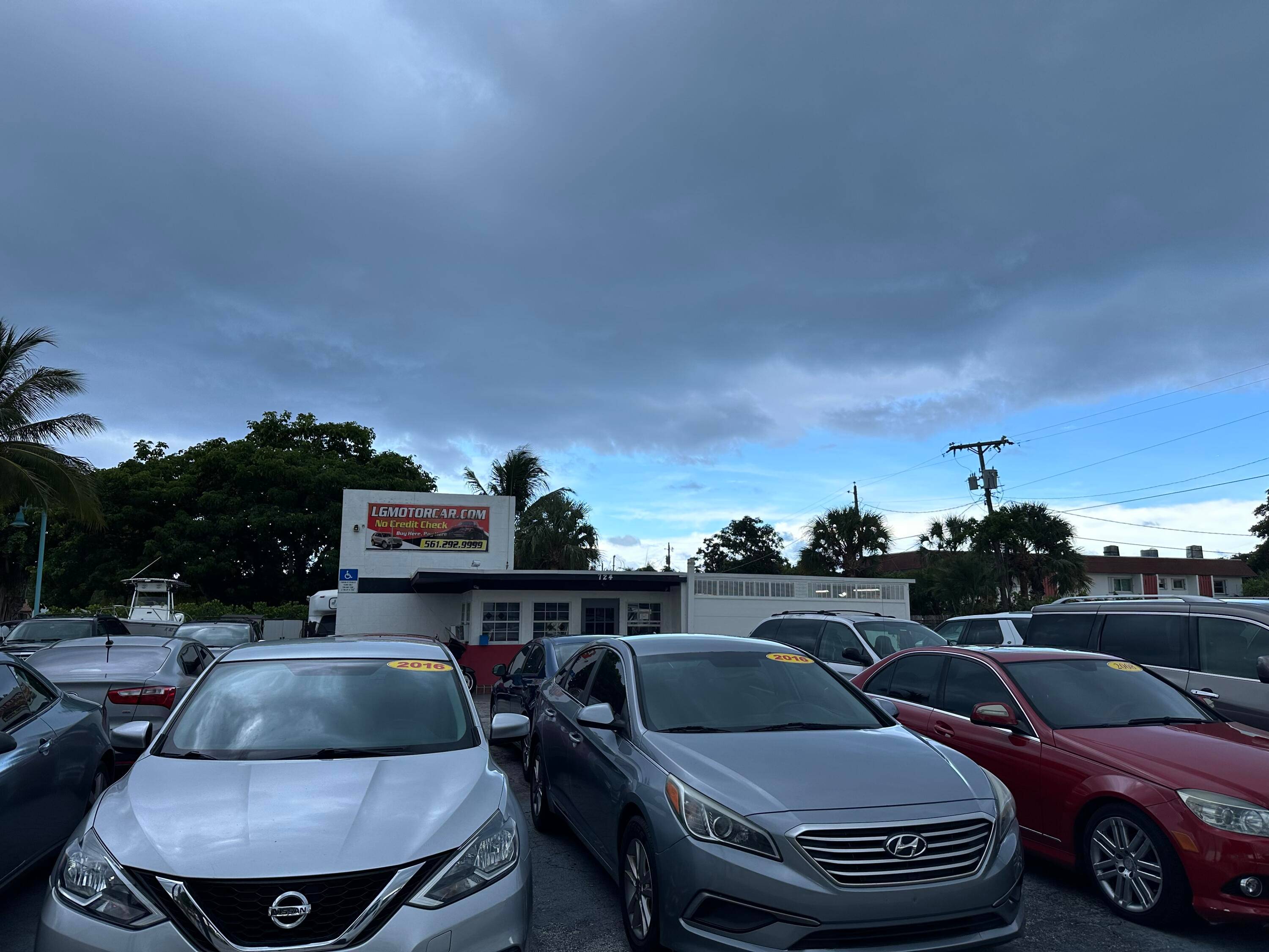Discover an exceptional commercial opportunity with this expansive corner lot on Federal Highway, currently hosting a successful car dealership.