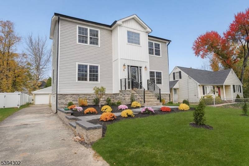 Welcome to this beautifully renovated Center Hall Colonial, offering a perfect blend of modern luxury and timeless elegance.