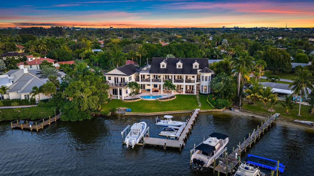 Discover this magnificent custom estate on the Loxahatchee River, featuring stunning waterfront views and breathtaking sunsets.